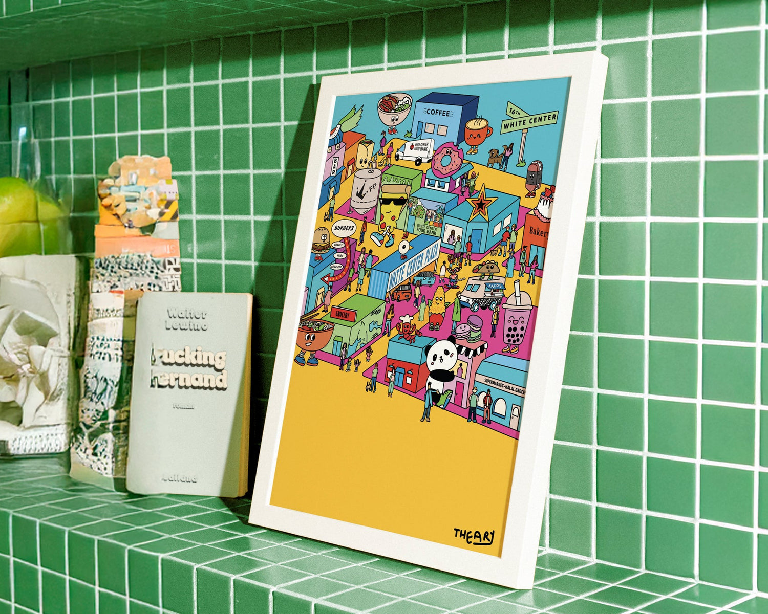 Framed colorful vibrant artwork on a green tiled shelf with various items.